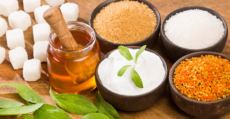 Pictured: Variety of sweeteners including stevia, sugar, pollen and honey | Credit: © AdobeStock/Luis Echeverri Urrea